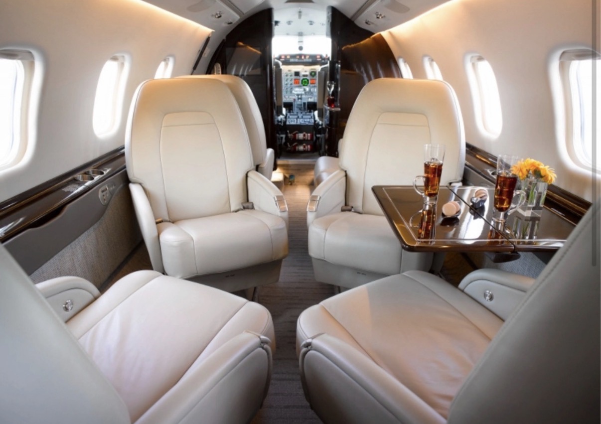 Cream leather club seats in a private jet cabin
