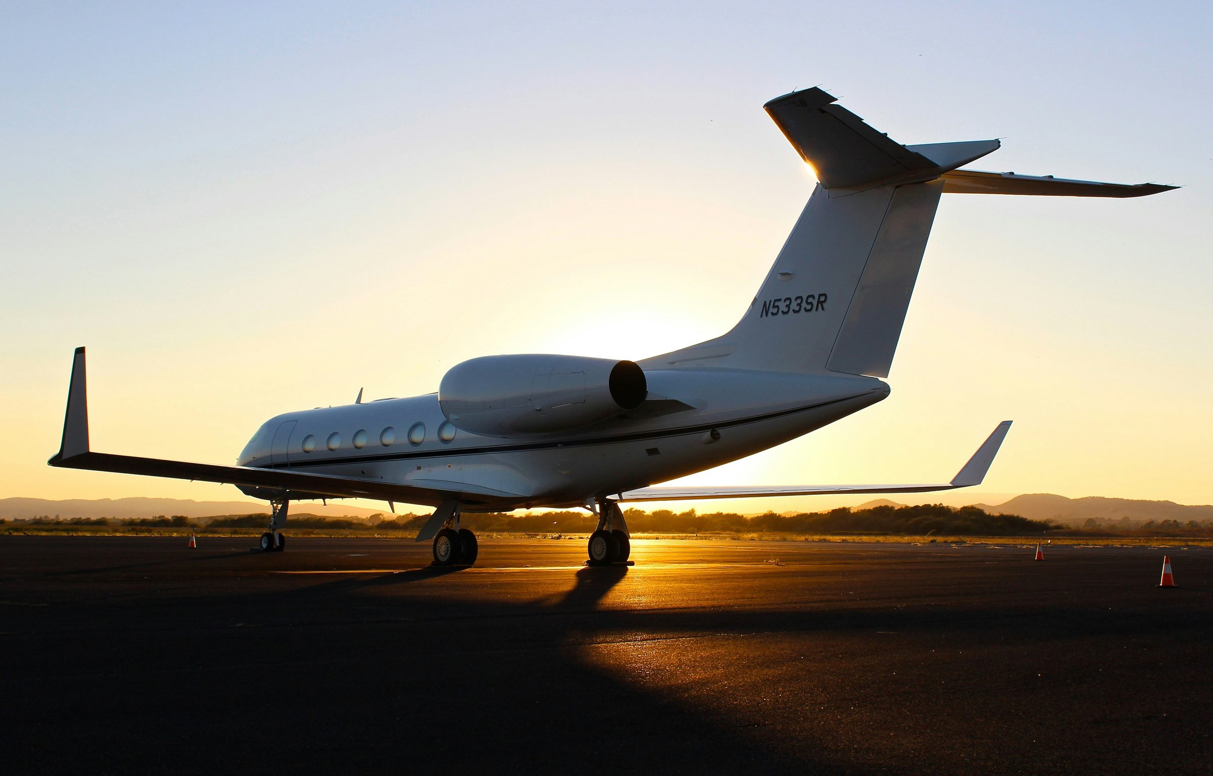 Private jet on the apron at sunset